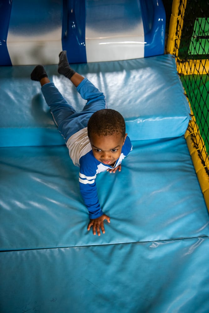 Child plays in soft play
